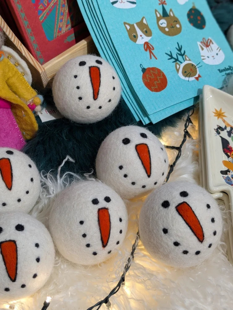 Cute wool snowman dryer balls with felt carrot noses and black eyes