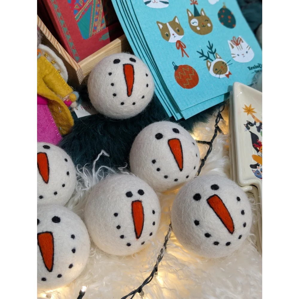 Cute wool snowman dryer balls with felt carrot noses and black eyes