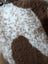 A plush fluffy grade a- sheepskin blanket with soft white and brown tibet highland spotted pattern