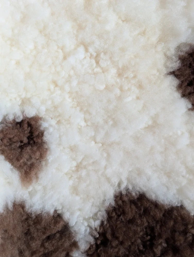 Cream and brown tibet highland spotted sheepskin rug with soft fluffy texture grade a- sheepskins
