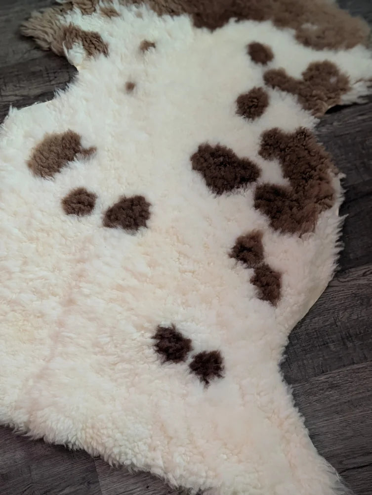 Cream-colored tibet highland spotted sheepskin rug with brown patches grade a- sheepskins for cozy decor