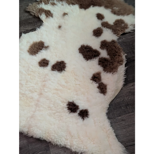 Cream-colored tibet highland spotted sheepskin rug with brown patches grade a- sheepskins for cozy decor