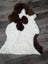 A plush tibet highland spotted grade a- sheepskin rug in white and brown cow print natural fur perfect for cozy decor
