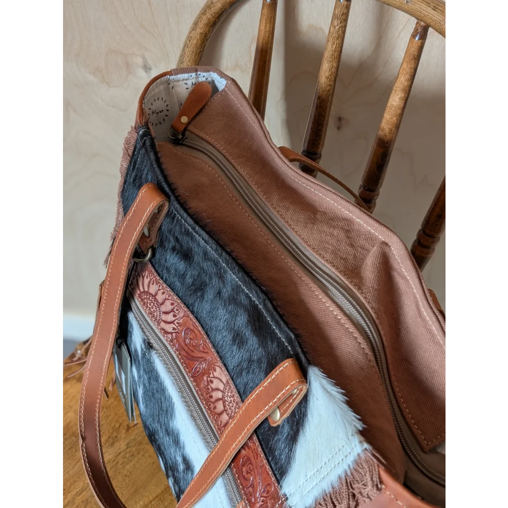 Brown and black real cowhide oakley bag with tan leather straps floral tooling and fringe detailing spacious bag