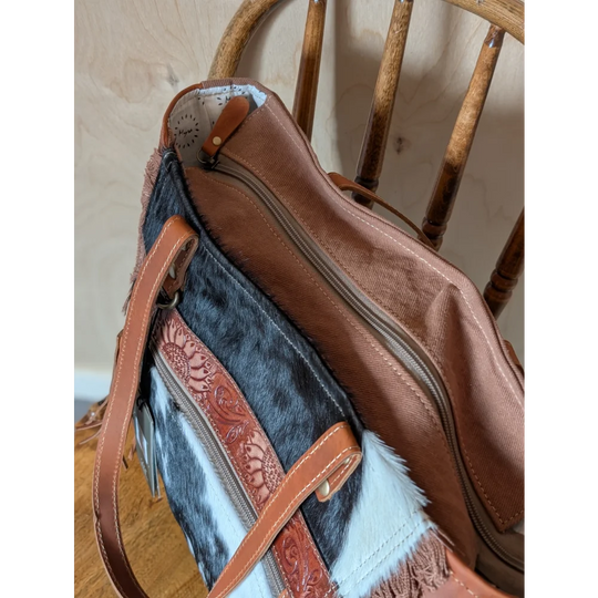 Brown and black real cowhide oakley bag with tan leather straps floral tooling and fringe detailing spacious bag