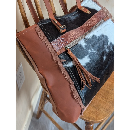 Rustic oakley bag with patchwork black and white real cowhide and spacious tan leather straps and embossed zippers