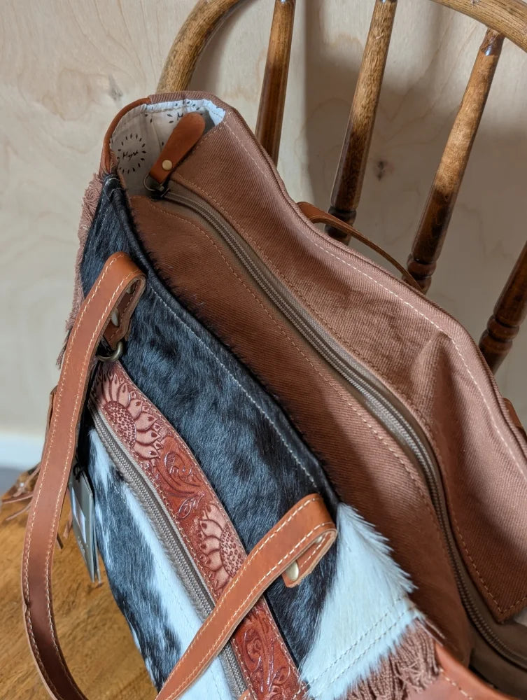 Brown and black real cowhide oakley bag with tan leather straps floral tooling and fringe detailing spacious bag