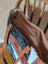 Brown and black real cowhide oakley bag with tan leather straps floral tooling and fringe detailing spacious bag