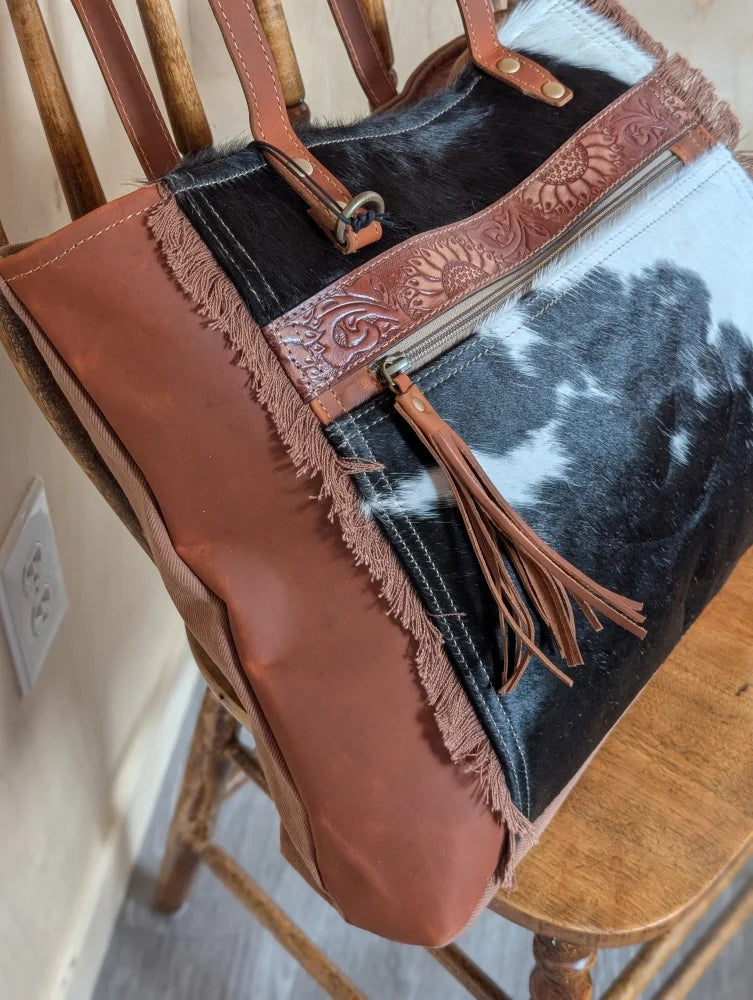 Rustic oakley bag with patchwork black and white real cowhide and spacious tan leather straps and embossed zippers