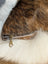 Brown faux fur merino sheepskin cushion with white fluffy trim and metallic zipper in cowhide merino sheepskin style