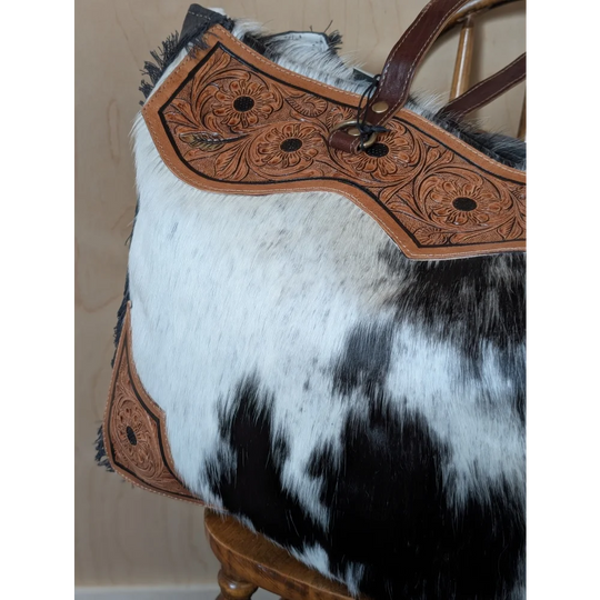 #4 the sunflower weekender bag with black and white hair-on hide, tan leather floral embroidery, and zippered pocket detail