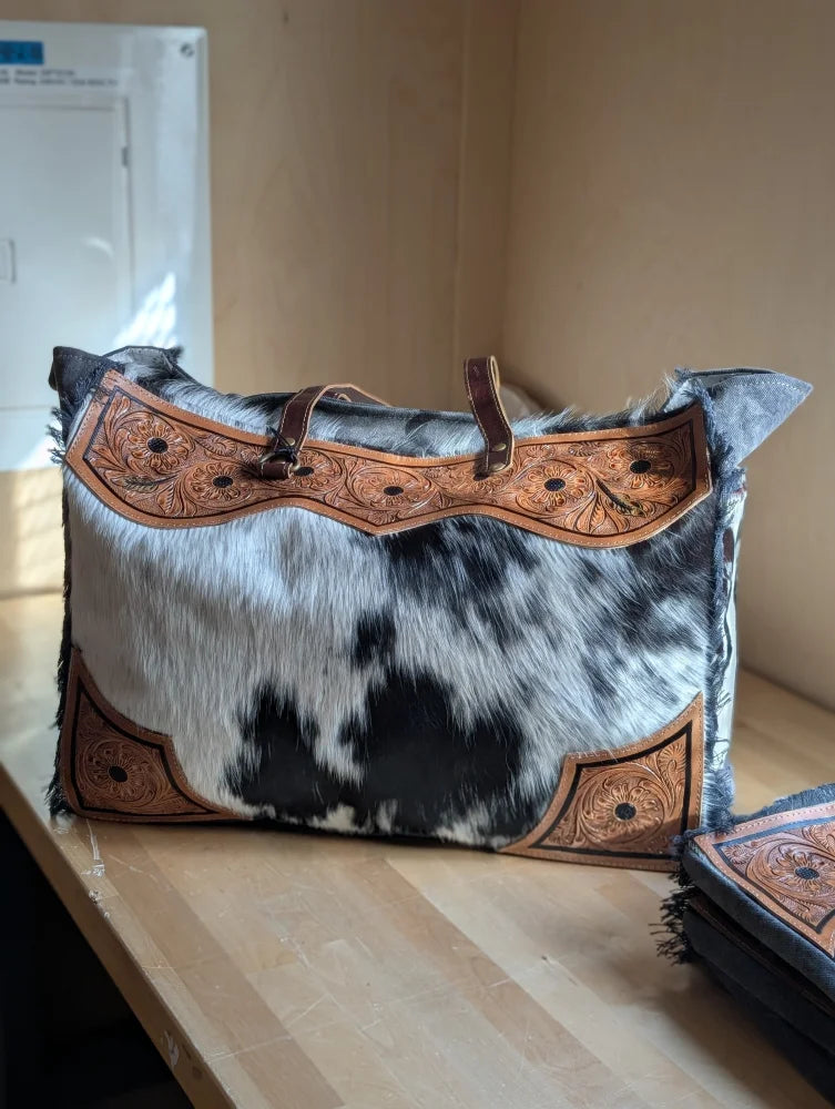 Black and white cowhide sunflower weekender bag with brown leather embroidery and zippered pocket hair-on hide cartwright hand-tooled bag