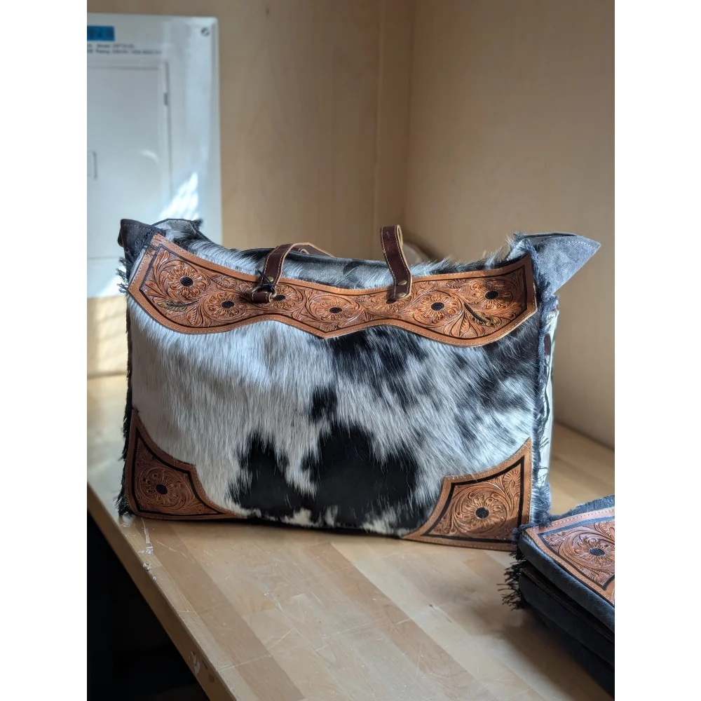 Black and white cowhide sunflower weekender bag with brown leather embroidery and zippered pocket hair-on hide cartwright hand-tooled bag