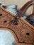 Brown leather horse halter with floral tooled patterns and black stitched outlines by cartwright hand-tooled bag