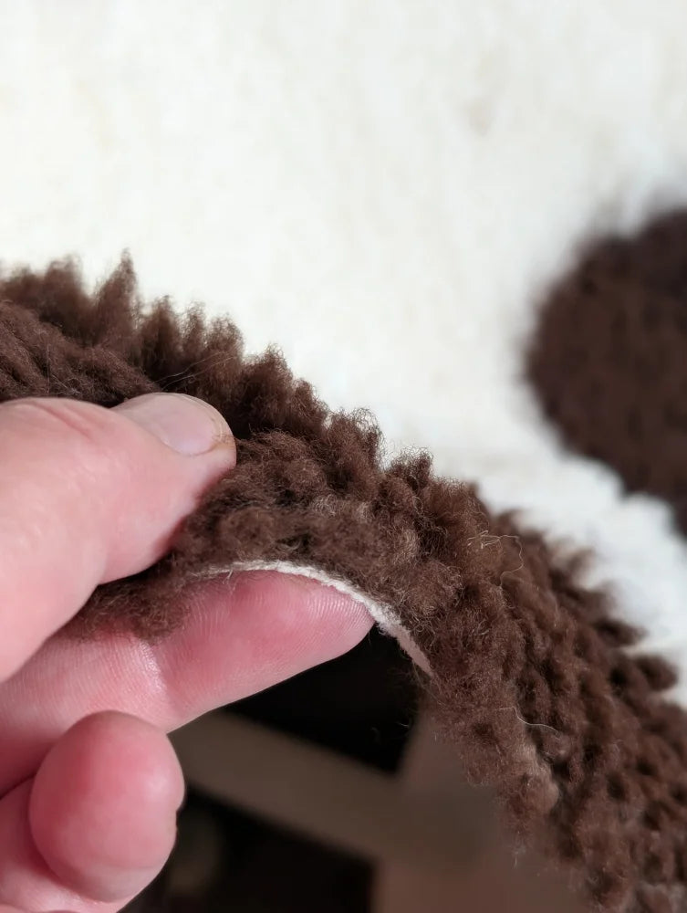 Brown fluffy highland spotted grade a- sheepskin with soft plush texture perfect for cozy decor or fashion