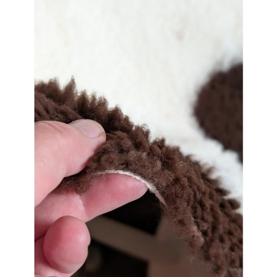Brown fluffy highland spotted grade a- sheepskin with soft plush texture perfect for cozy decor or fashion