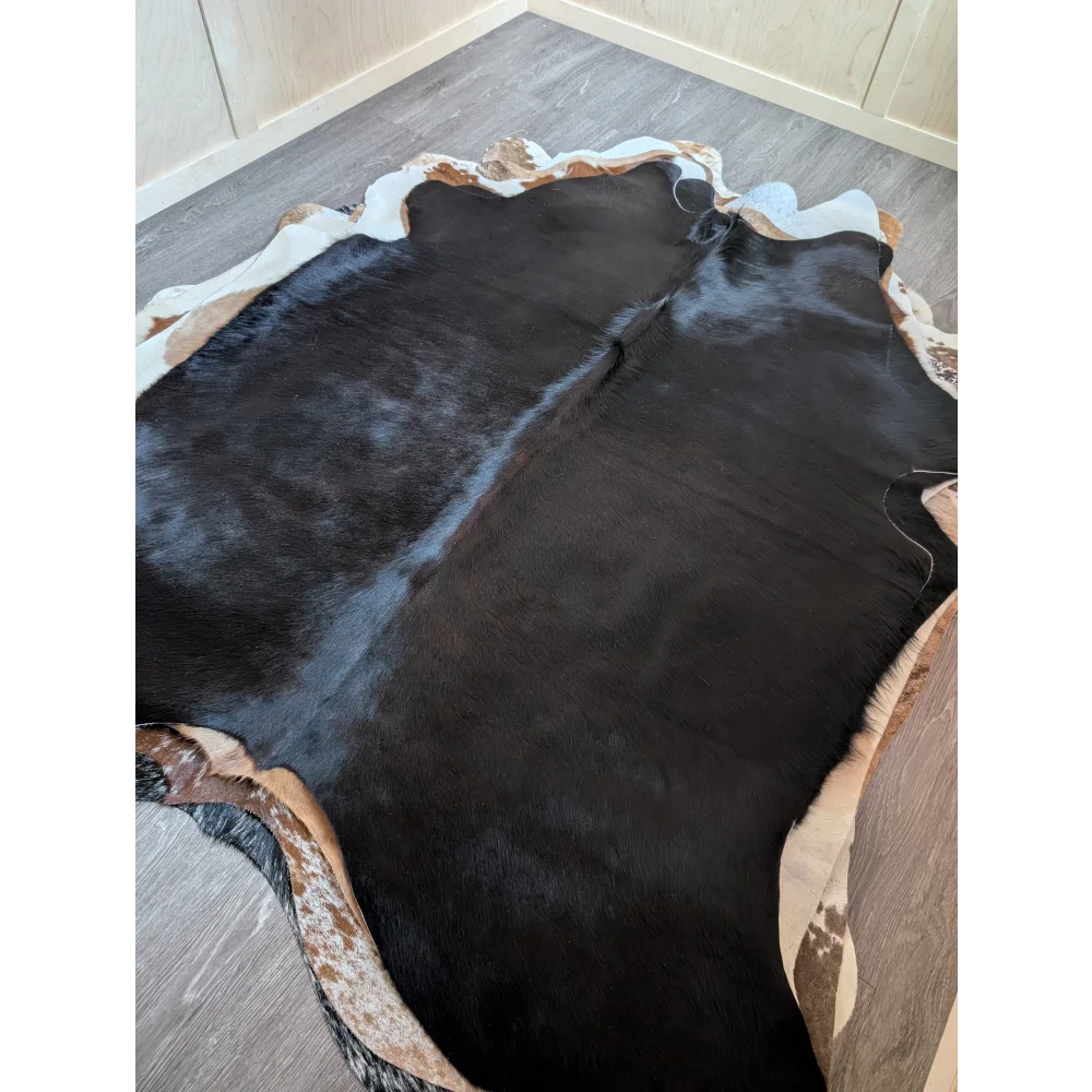 Large black and white cowhide rug with natural irregular edges perfect for beautiful rugs and decor