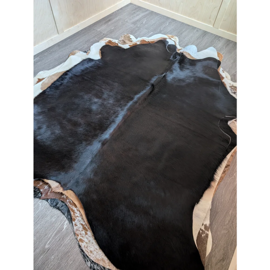 Large black and white cowhide rug with natural irregular edges perfect for beautiful rugs and decor