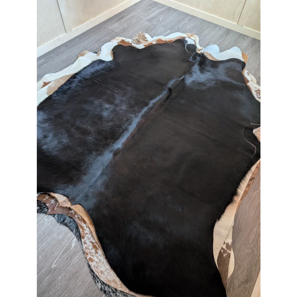 Large black and white cowhide rug with natural irregular edges perfect for beautiful rugs and cozy spaces