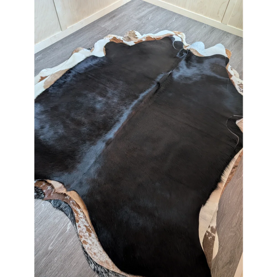 Large black and white cowhide rug with natural irregular edges perfect for beautiful rugs and cozy spaces