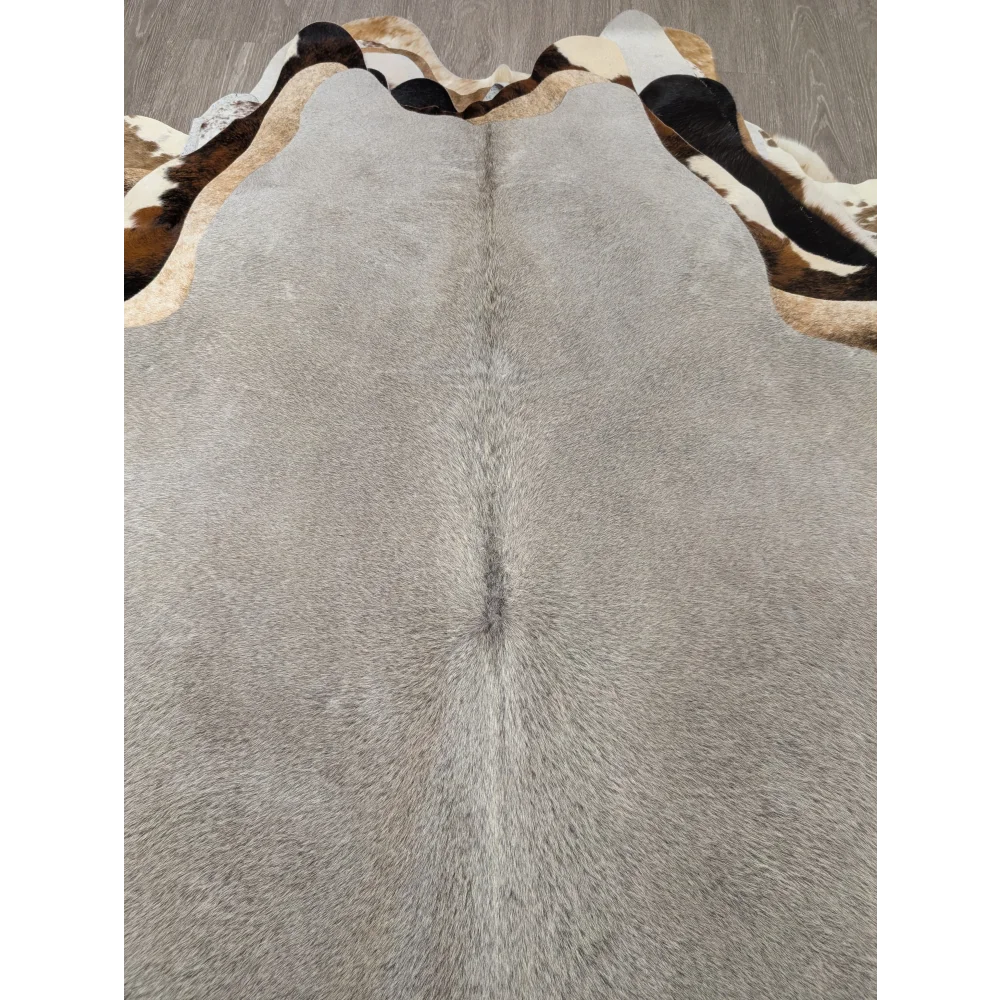 Large lovely cowhide rug gray with textured surface and distinctive black and white patterned border 77.5 x 66 inches