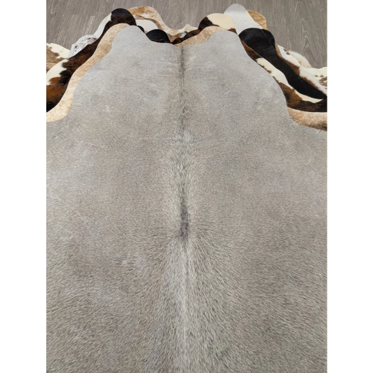 Large lovely cowhide rug gray with textured surface and distinctive black and white patterned border 77.5 x 66 inches