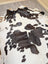 A lovely large cowhide rug in black and white spotted natural cowhide measuring 77 by 64 inches