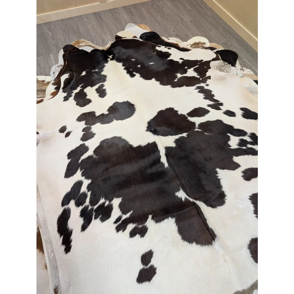Large lovely cowhide rug 77 x 64 with black and white pattern and natural irregular edges perfect for home decor