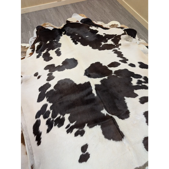 Large lovely cowhide rug 77 x 64 with black and white pattern and natural irregular edges perfect for home decor