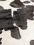 A lovely black and white large cowhide rug with natural textured surface measuring 77 by 64 inches