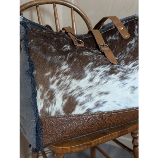 Brown and white cowhide tote bag with tan leather straps and embossed brown leather base from matty affair canvas