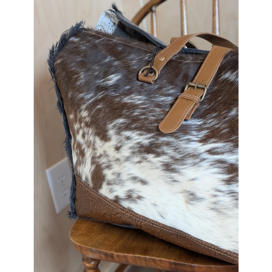Brown and white cowhide matty affair canvas tote bag with tan leather straps and embossed base by angus oliver