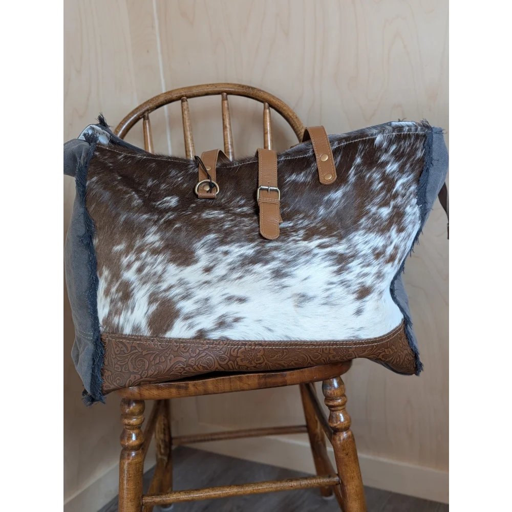 Brown and white cowhide matty affair canvas tote bag with tan leather straps and embossed base by angus oliver