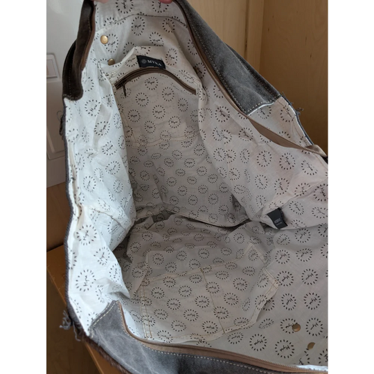 White canvas tote bag with black circular pattern, denim accents, and brown leather trim from matty affair canvas by angus oliver