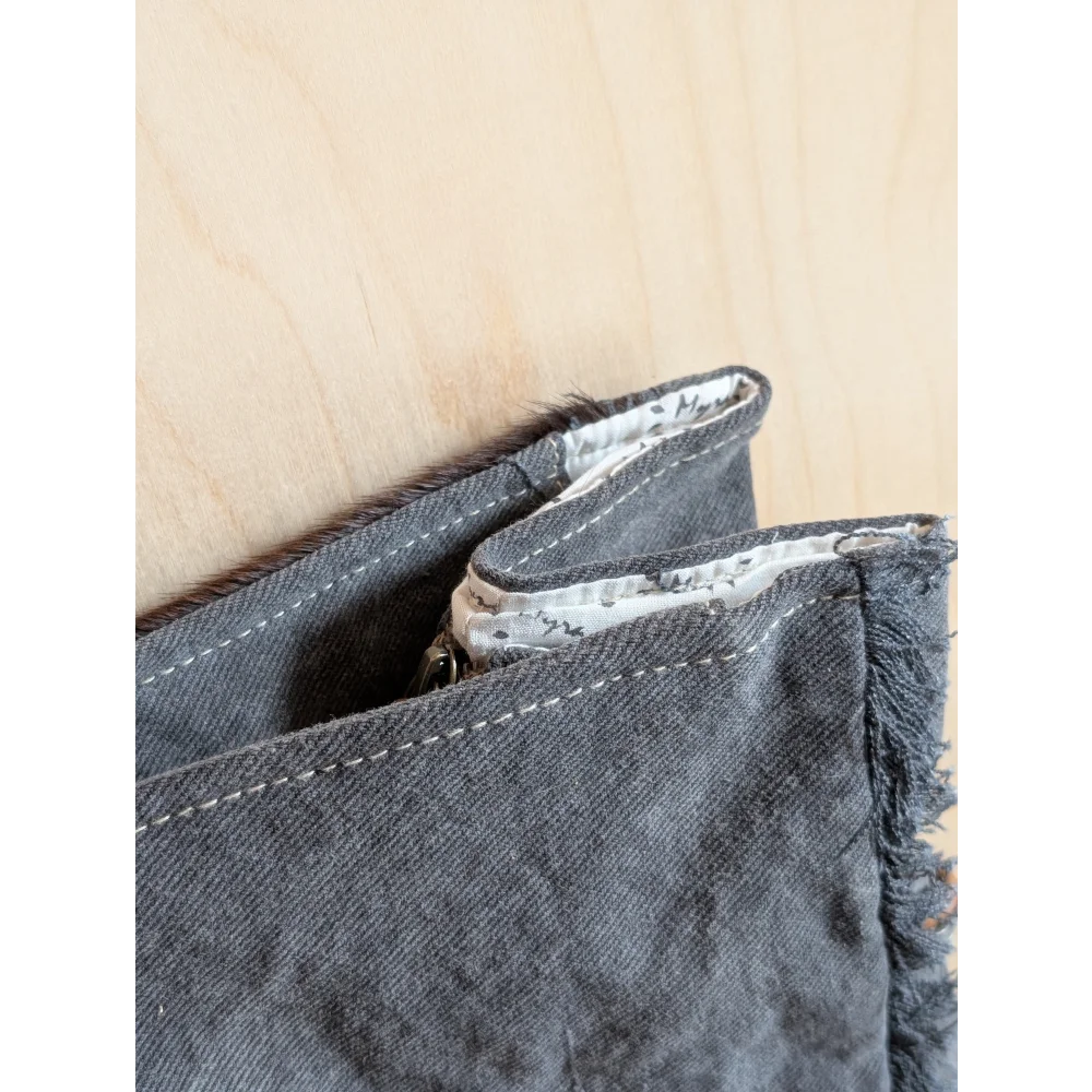 Dark gray denim wallet with frayed edges and zipper pull from the matty affair canvas and angus oliver collection