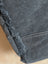 Dark gray denim fabric with frayed edges and white stitching on matty affair canvas weekender bag by angus oliver