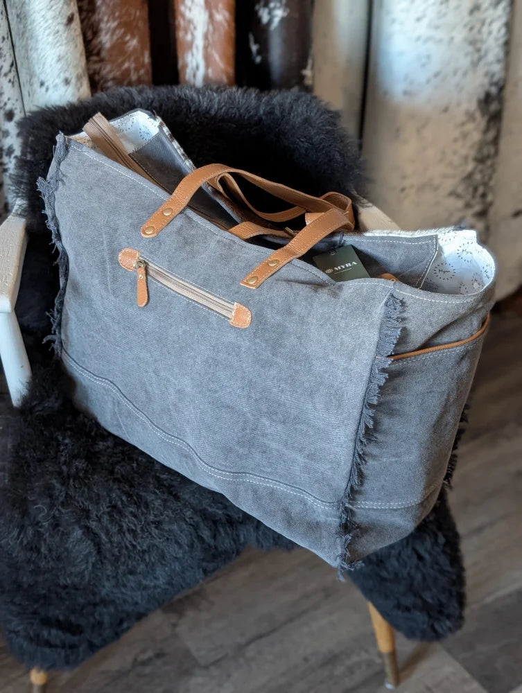 Matty Affair canvas hair on weekender bag with gray tote frayed edges