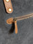 Tan leather zipper pull with metallic slider and brass studs on matty affair canvas weekender bag by angus oliver