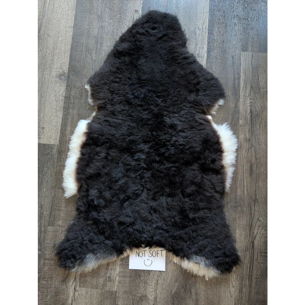 Black and white standard grade short wool white icelandic sheepskin rug with plush natural fur texture