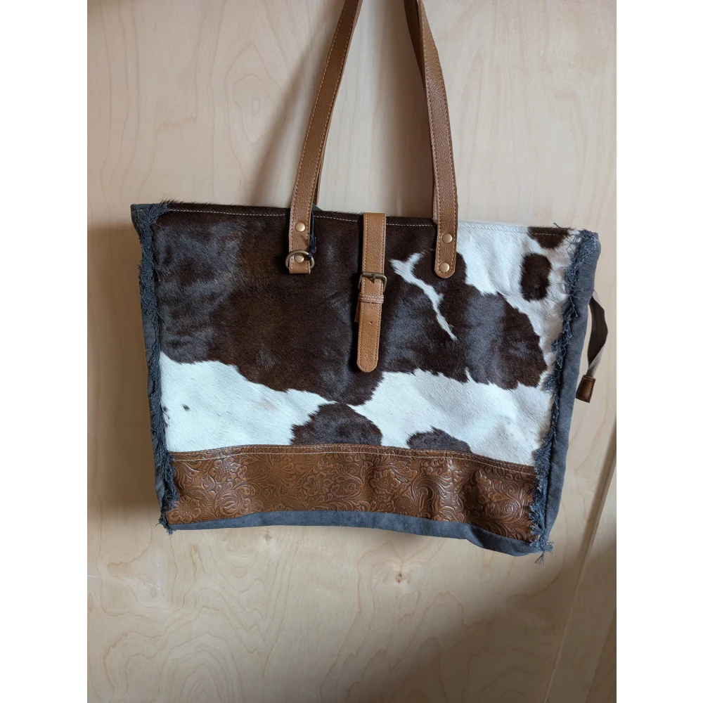 Brown and white cowhide tote bag with tan leather straps and embossed brown leather band from angus oliver matty affair canvas