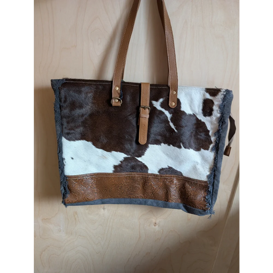 Brown and white cowhide tote bag with tan leather straps and embossed brown leather band from angus oliver matty affair canvas
