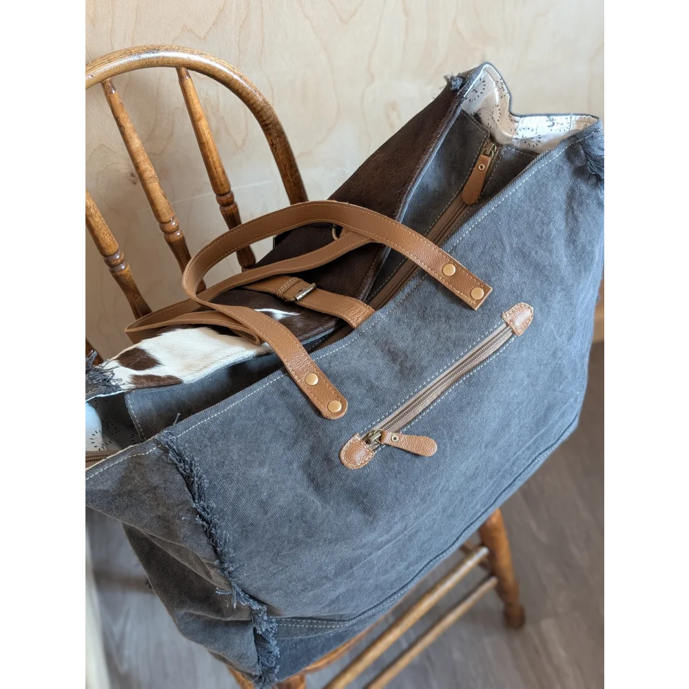 A denim matty affair canvas tote bag with brown leather handles and distressed edges by angus oliver