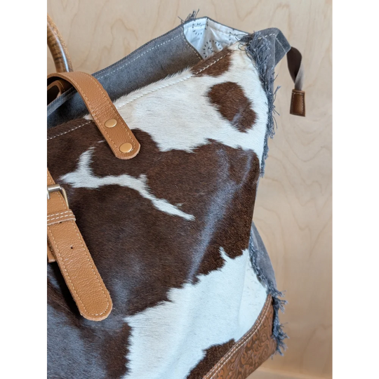Brown and white cowhide weekender tote bag with tan leather straps from matty affair canvas by angus oliver