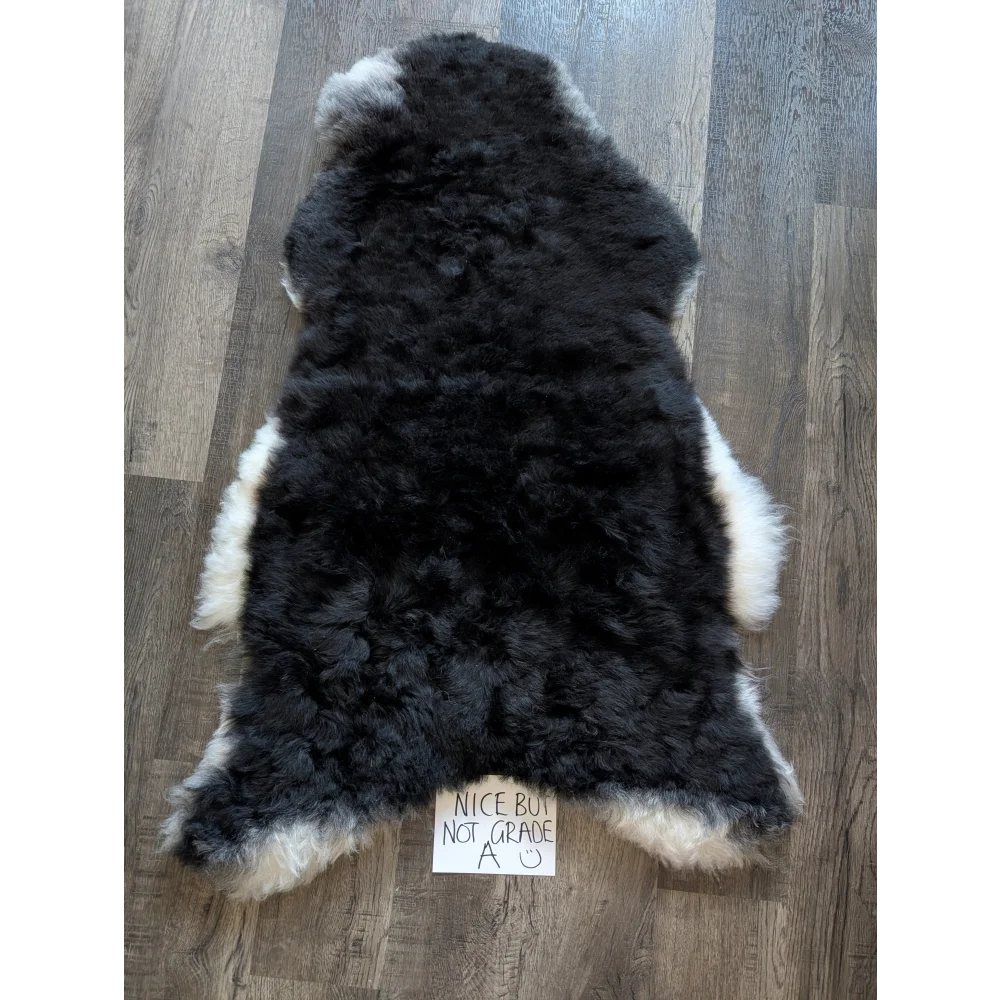 Black and white standard grade short wool white icelandic sheepskin rug with fluffy natural fur texture