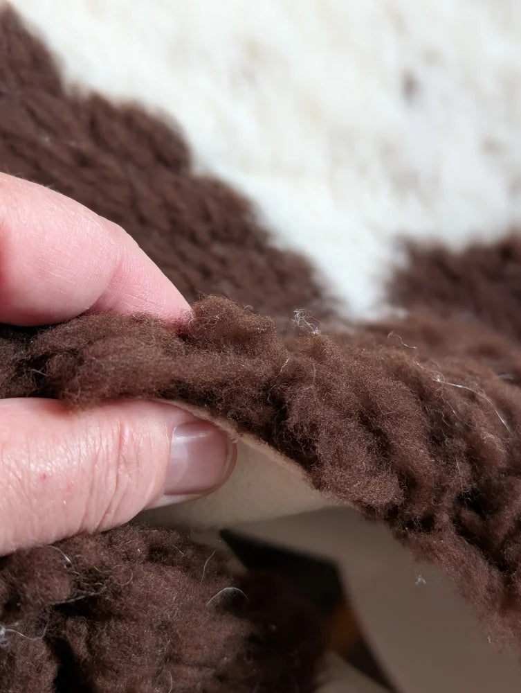 Brown fluffy yarn with soft textured knit made from grade a- highland spotted sheepskins for cozy projects
