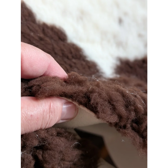 Brown fluffy yarn with soft textured knit made from grade a- highland spotted sheepskins for cozy projects