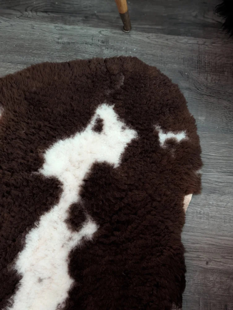 Brown and white fluffy tibet highland spotted grade a- sheepskin rug with a soft textured surface