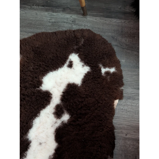 Brown and white fluffy tibet highland spotted grade a- sheepskin rug with a soft textured surface