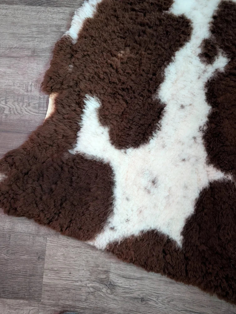 Brown and white highland spotted grade a- sheepskin rug with soft fur perfect for cozy home decor