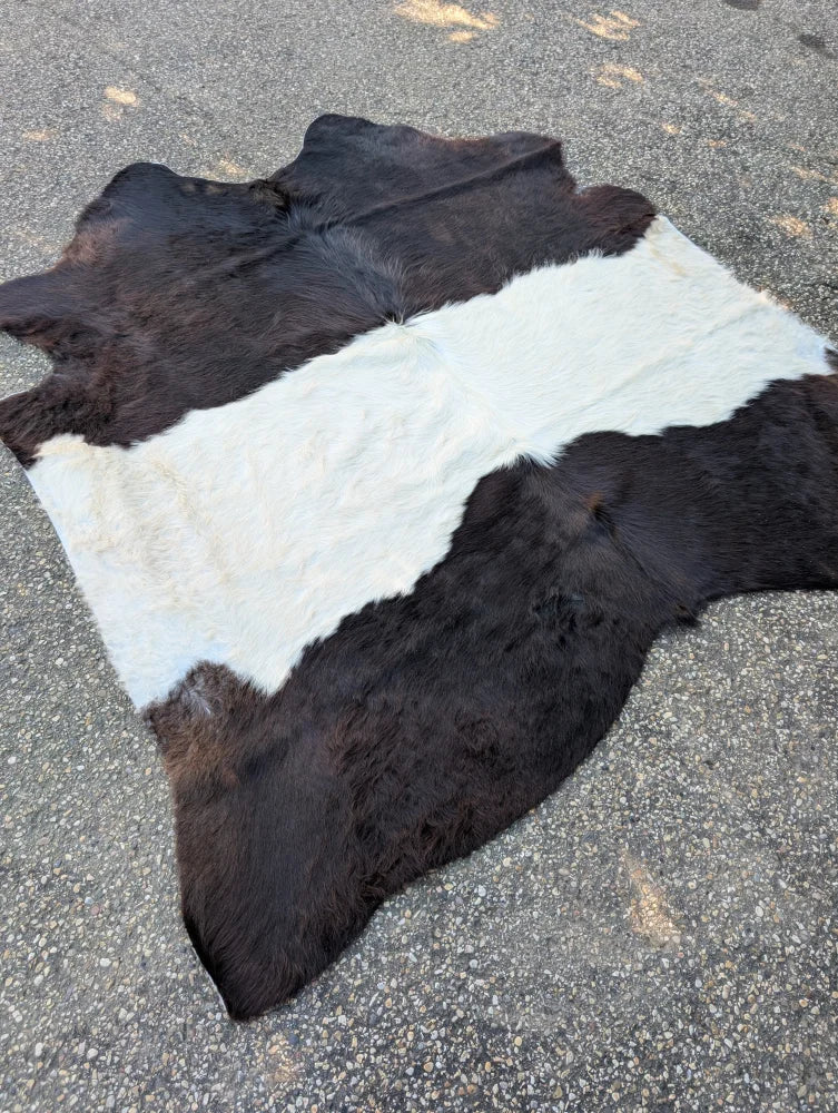 Large cowhide 77 x 76 belted galloway rug with striking black and white pattern and soft fluffy fur texture